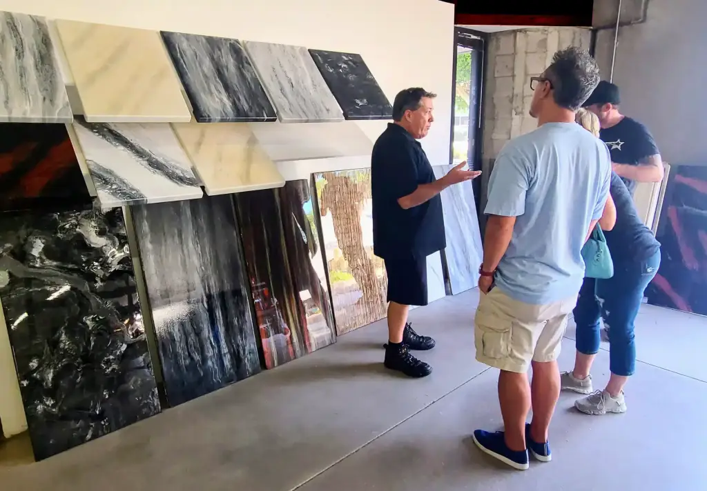 Samples of Epoxy Countertops at the Counter Intelligence Showroom, with customers browsing the samples and learning about the process from one of the Epoxy Countertop experts.